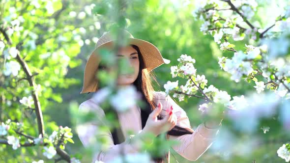 Beauty Young Woman Enjoying Apple Blooming Spring Orchard.