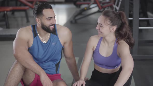 Handshake of Sportive Young Man and Woman in Gym