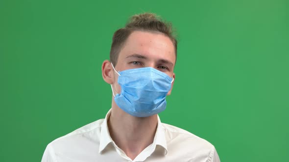 Young Handsome Man Takes Off Protective Medical Mask From Face