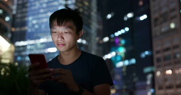 Man use of mobile phone at night