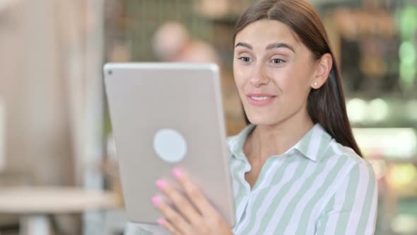 Portrait of Young Latin Woman Doing Video Call on Digital Tablet