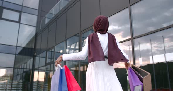 Black Woman Throwing Shopping Bags Into the Air