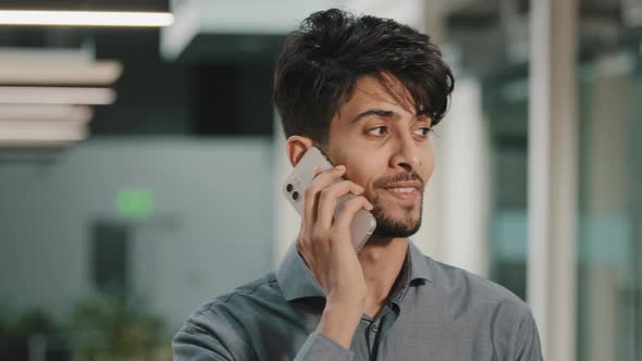 Smiling Young Arabian Guy Multiracial Business Man Calling Mobile Phone at Workplace Hispanic Worker