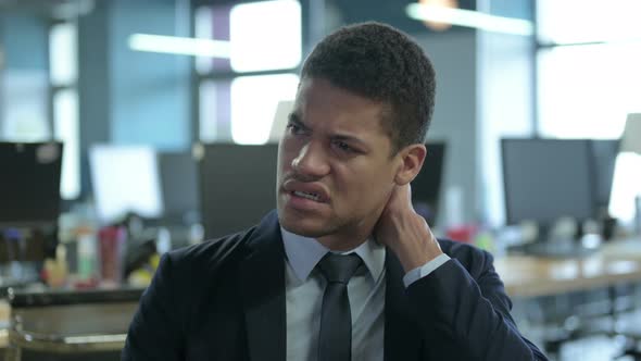 Portrait of African Businessman Having Neck Pain in Office