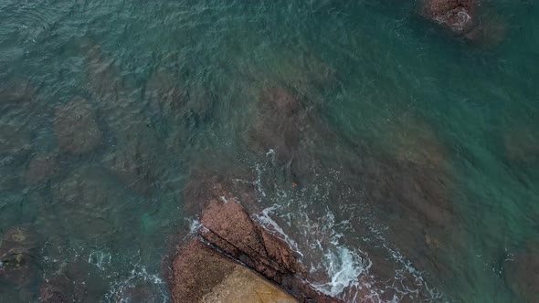 Aerial View of a Rocky Coastline with Waves