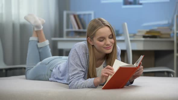 Teenage Girl Reading Book Dreaming of Romantic Love