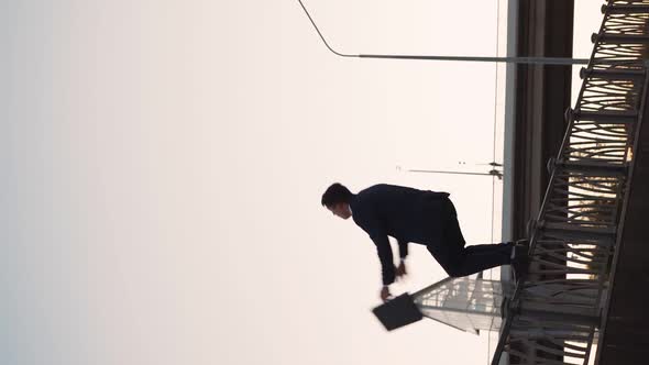 Successful Businessman with Business Briefcase is Doing Back Somersault