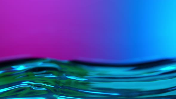 Super Slow Motion Abstract Shot of Swirling Neon Water at 1000Fps