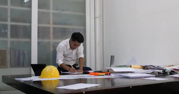 Asian Architect Working In The Office alt