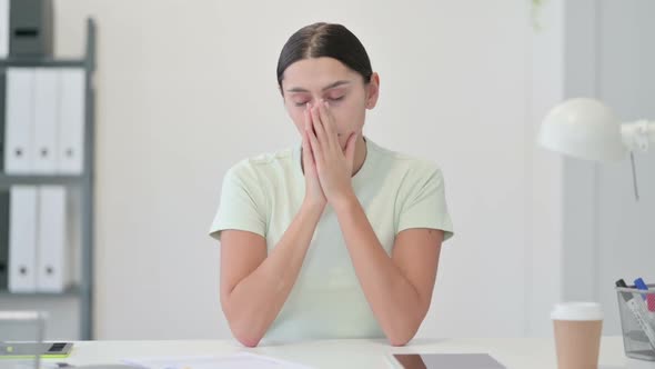 Sick Young Latin Woman Sneezing in Office