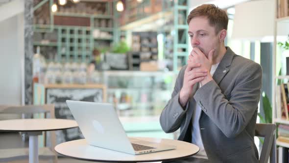 Young Man with Laptop Having Loss Failure