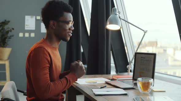 Happy Black Businessman Posing for Camera in Office