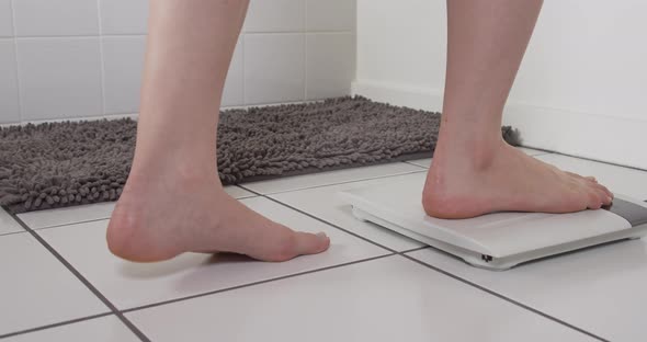 Woman Checking Weight Bathroom Scale