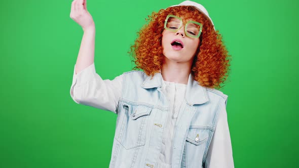 Cute Young Redhead Curly Woman Wearing Panama Hat and Eyeglasses Showing Bellissimo Gesture