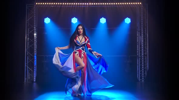 Slender High Girl Dancing in a Sexy Suit in the Color of the English Flag and Rhinestones