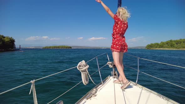 Girl Greeting with Her Hand on Sailboat