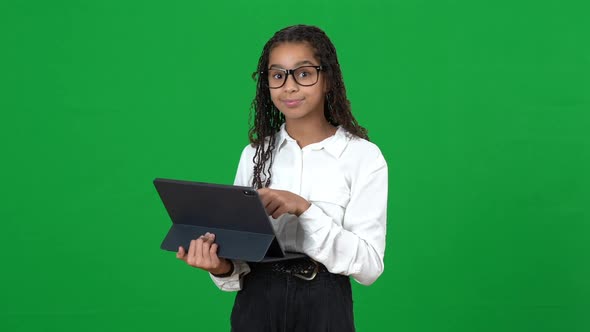 Genius African American Teen Girl Using Tablet Showing I Got an Idea Gesture on Green Screen