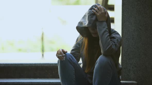 Young Upset Female Smoking Cigarette Alone on Stairs, Depression and Problems