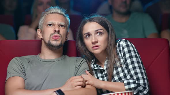 Closeup Couple Watching Horror Film with Afraid Face Expression at Cinema Thriller Premiere