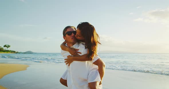 Couple Walking on the Beach at Sunset