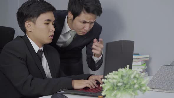 serious stressed two business man using laptop computer to working project