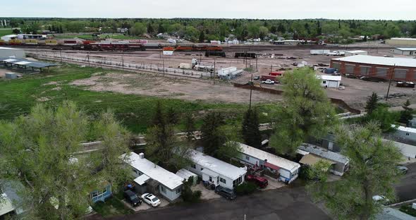 Mobile home park next to an industrial district showing poverty and wealth disparity in 2021.