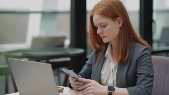 Young Businesswoman Use Smart Phone with Laptop