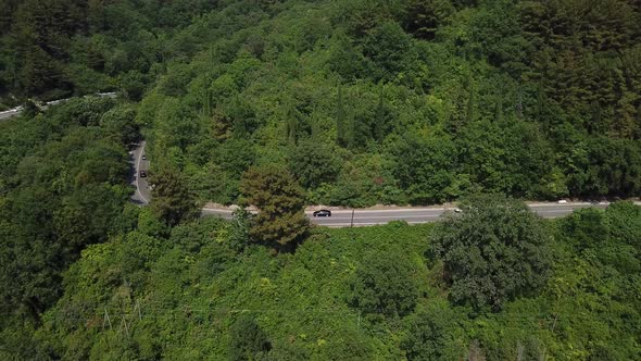 Aerial View From Above of Curve Road with a Car on the Mountain with Green Forest in Russia