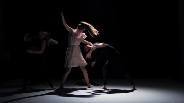 Continue of Contemporary Dance Performance of Five Dancers on Black, Shadow