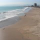 A man runs with a dog, pacific ocean coast beach (Coquimbo, Chile) aerial view - VideoHive Item for Sale