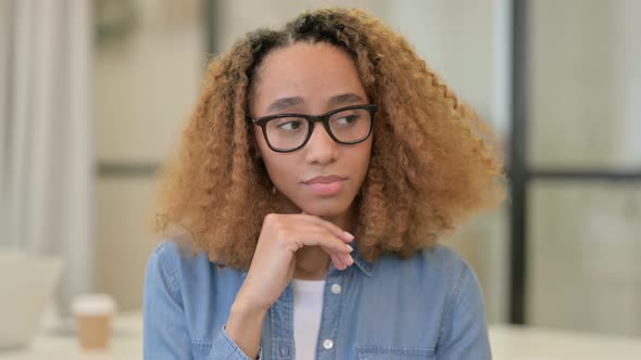 Portrait of Pensive African Woman Thinking Getting Idea