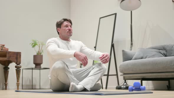 Portrait of Hands of Man Meditating on Yoga Mat at Home