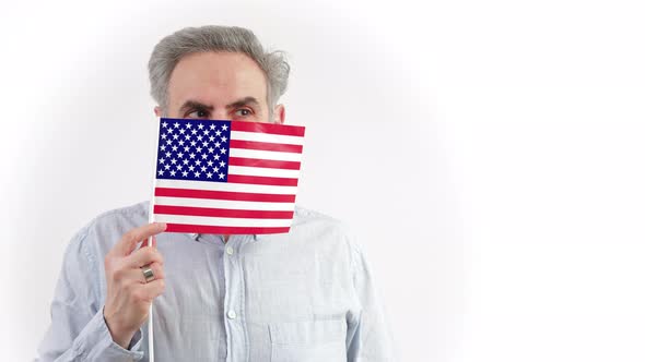 40s Caucasian Man Hiding Behing the US Flag and Looking Around