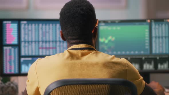 African American Broker Analyzing Charts