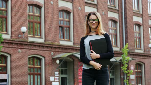 Portrait of Female Student or Freelancer, Woman in Glasses Standing with Laptop and Looking