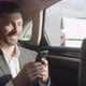 Close Up of a Relaxed Calm Businessman is texting Messages while traveling in the Car. - VideoHive Item for Sale