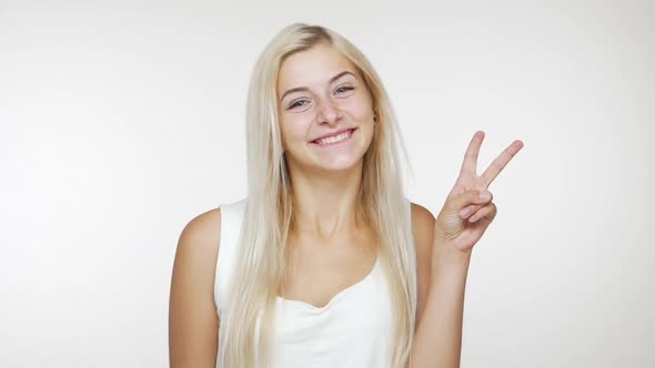 Slomo Beautiful Blond Lady Smiling Winking Showing Victory Sign with Two Hands Giving Air Kiss on