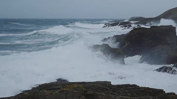 Dramatic Ocean Waves Crashing On Rocks At Calf Of Man, Isle Of Man. Slow Motion And Locked Off