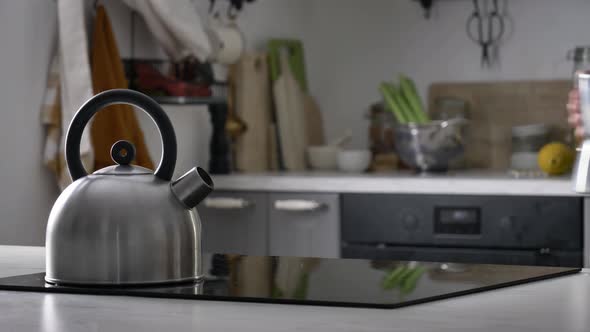 Woman make a coffee in moka pot in kitchen