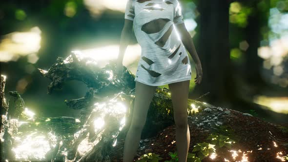 Young Woman in Torn Tshirt in Green Forest alt