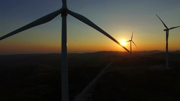 Flying close to windmill blades at dusk