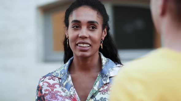 A smiling activist afro-american woman talking to group of people while enjoying march on street for