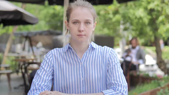 Online Video Chat By Young Woman Sitting in Cafe Terrace