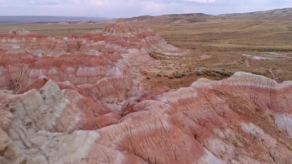 Flying up and over red desert hills to get aerial view of the Wyoming landscape