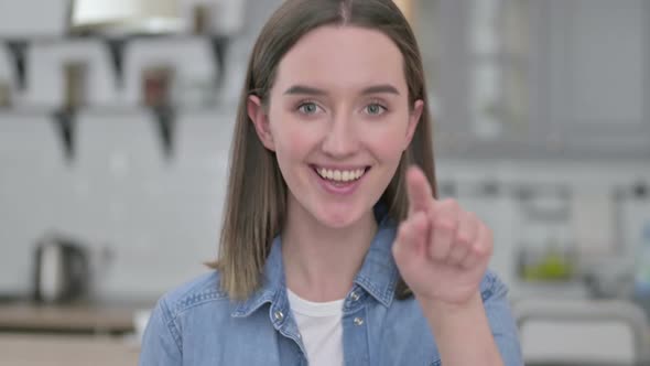 Portrait of Cheerful Young Woman Pointing and Inviting