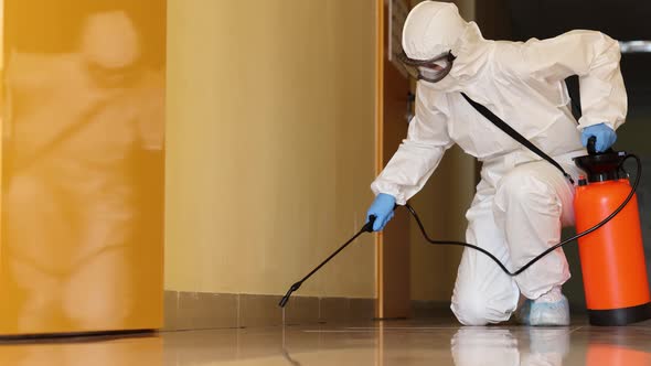 Employee in Protective Suit Wearing Protective Mask Disinfects Room  Movie