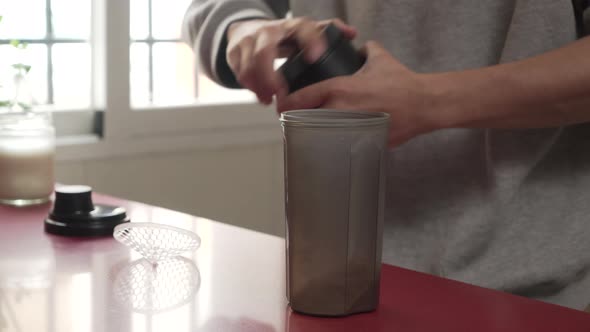 Man Making Protein Shake after Exercise