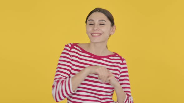 Spanish Woman Dancing in Joy on Yellow Background