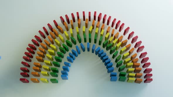 Line up of Dominoes in Rainbow Falling Colors with LGBT Colors of a Hand