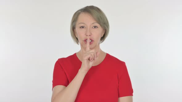 Silence Please Old Woman with Finger on Lips on White Background